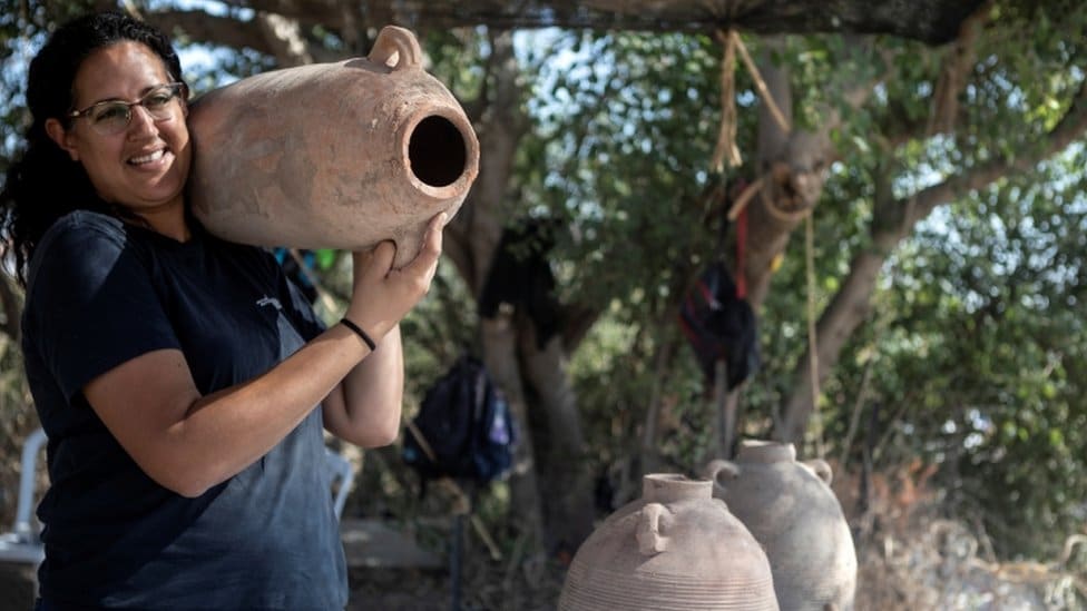 Archaeologist carries Gaza Jar at the site