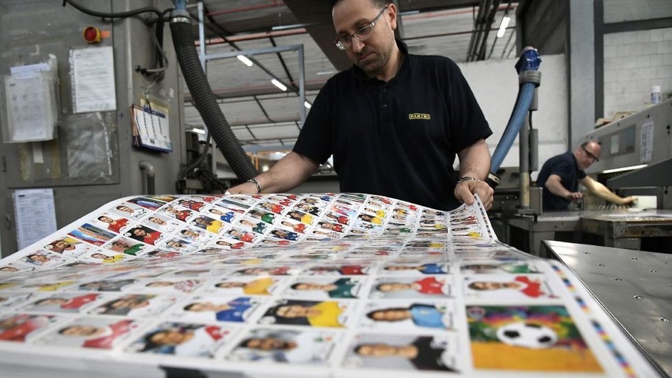 A worker prepares sheets of stickers at the Panini factory in Italy ahead of the 2018 World Cup