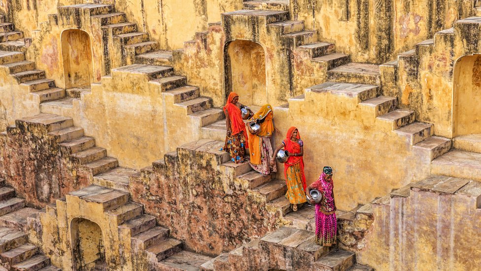 Indian women carrying water from stepwell near Jaipur, Rajasthan, India.