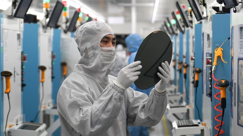 Employees work on the production line of silicon wafer at a factory of GalaxyCore Inc. on May 25, 2021 in Jiashan County, Jiaxing City, Zhejiang Province of China.