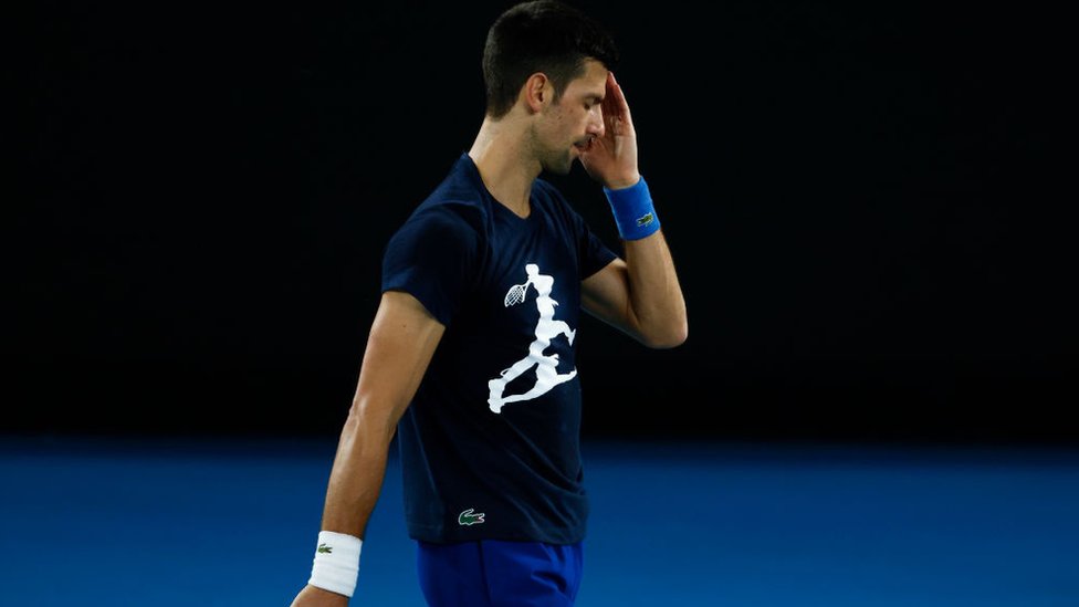 Novak Djokovic of Serbia reacts during a practice session ahead of the 2022 Australian Open at Melbourne Park on January 14, 2022 in Melbourne, Australia.