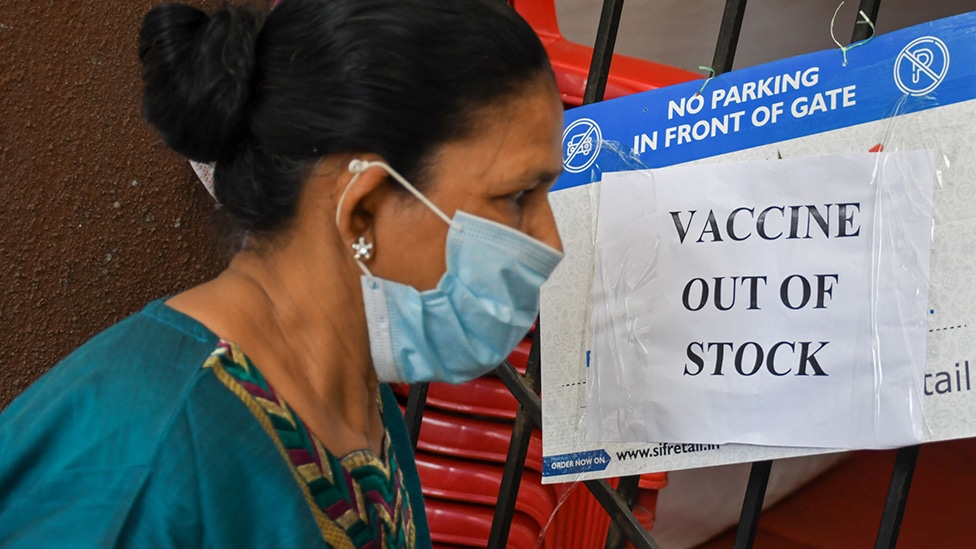 2021/04/08: A woman wearing a facemask as a precaution against the spread of covid-19 seen reading a poster saying 'vaccine out of stock' outside a vaccination center in Mumbai