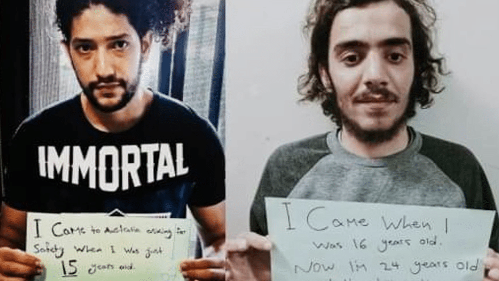 Refugees Mehdi Ali (left) and Mohammad (right) hold up signs saying they arrived in Australia as teenagers and have been detained for a decade