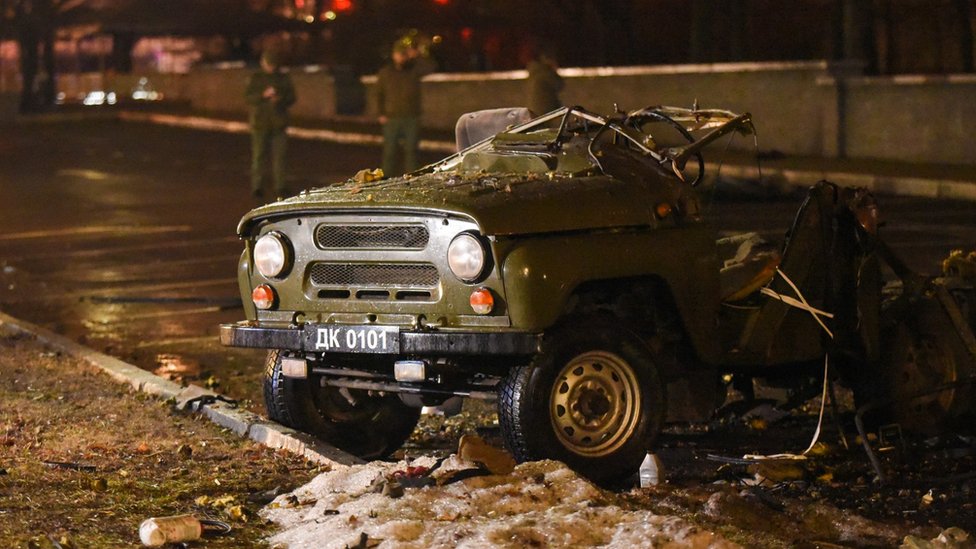 A car blown up on a parking lot outside a government building in central Donetsk.