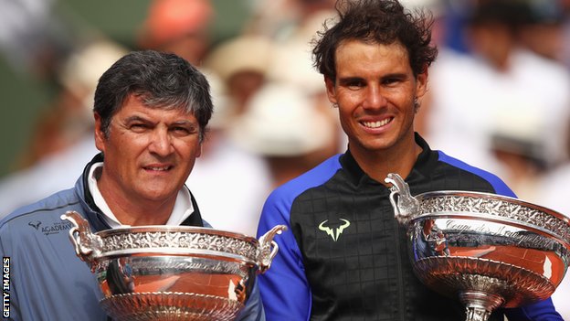 Toni Nadal and Rafael Nadal pose with trophies after their final French Open together in 2017