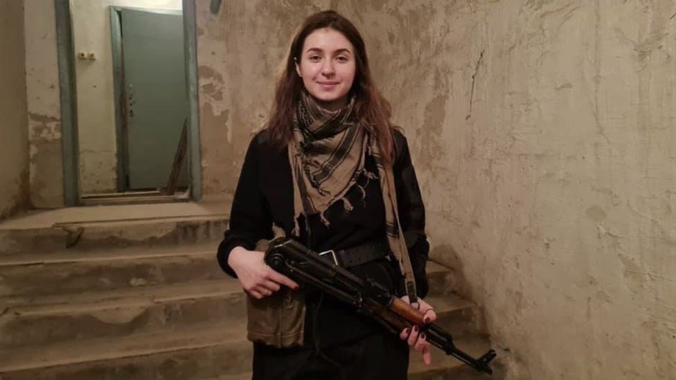 Yaryna Arieva holding a rifle