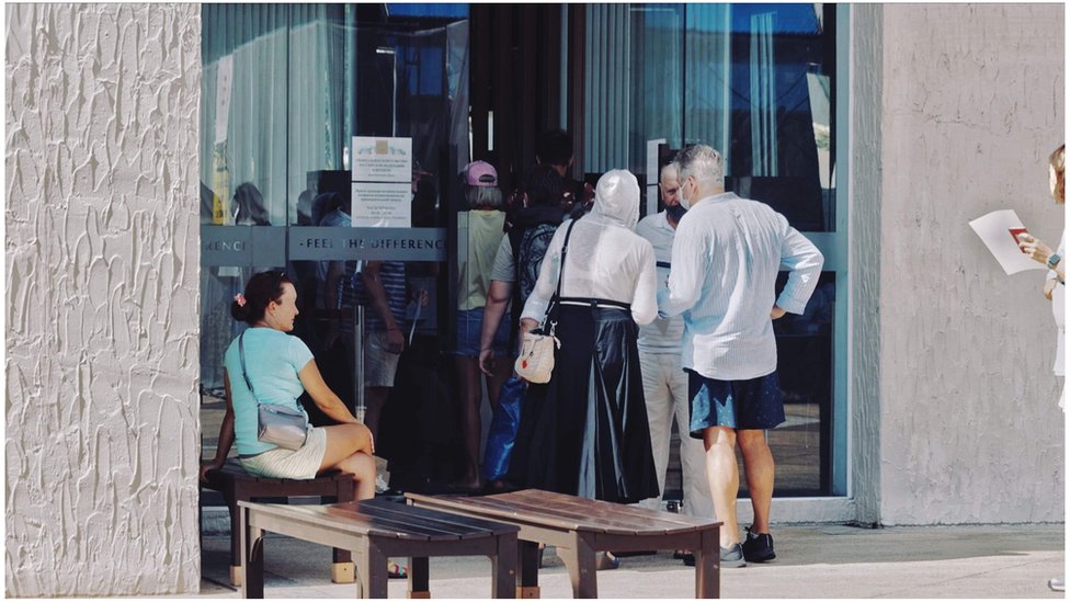 People queue outside a Thai office