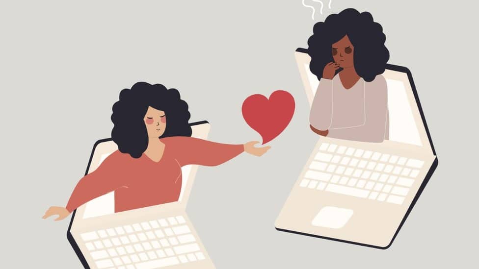 An illustration of two women reaching out to one another from inside laptops with a heart between them