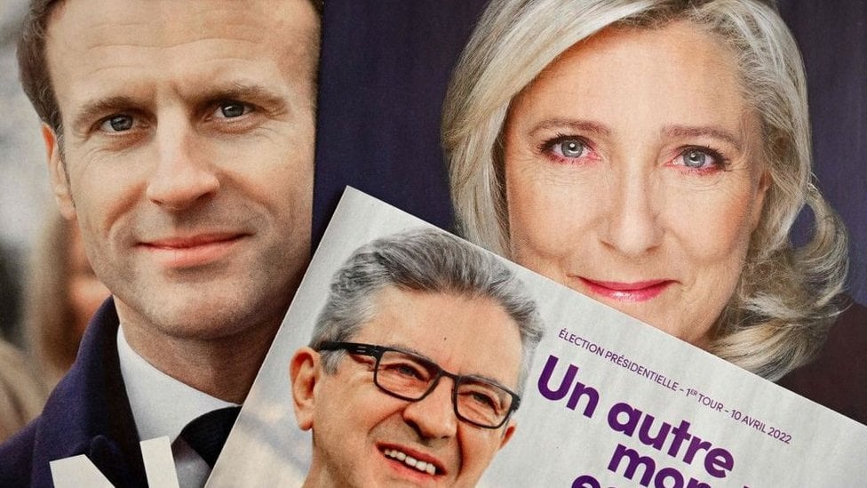 This picture taken on April 6, 2022 in Marseille, southern France, shows folded electoral leaflets of Emmanuel Macron (L), Jean-Luc Melenchon (C) and Marine Le Pen