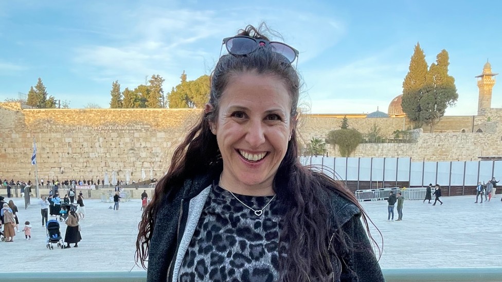 Keren Troyner stands in front of the Western Wall in Jerusalem's Old City