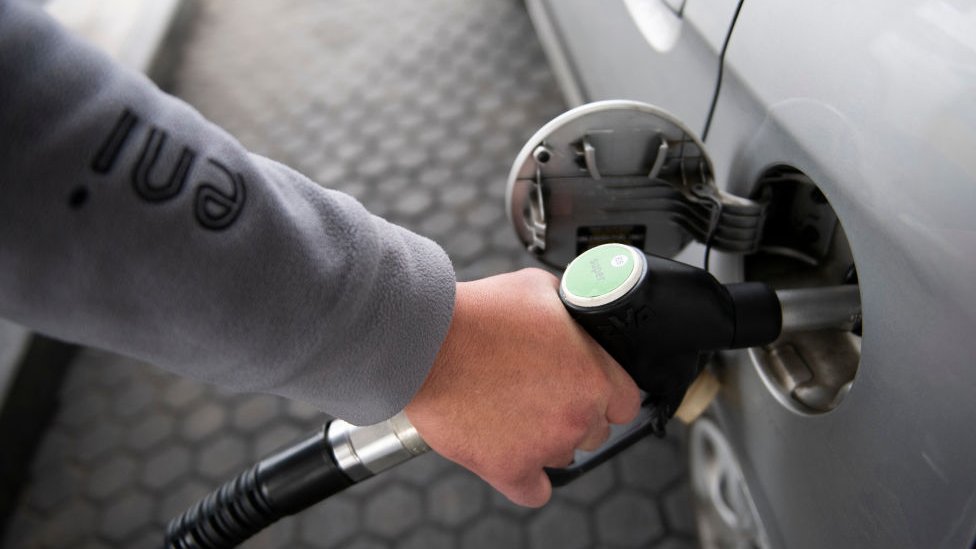Man refueling a car with gasoline