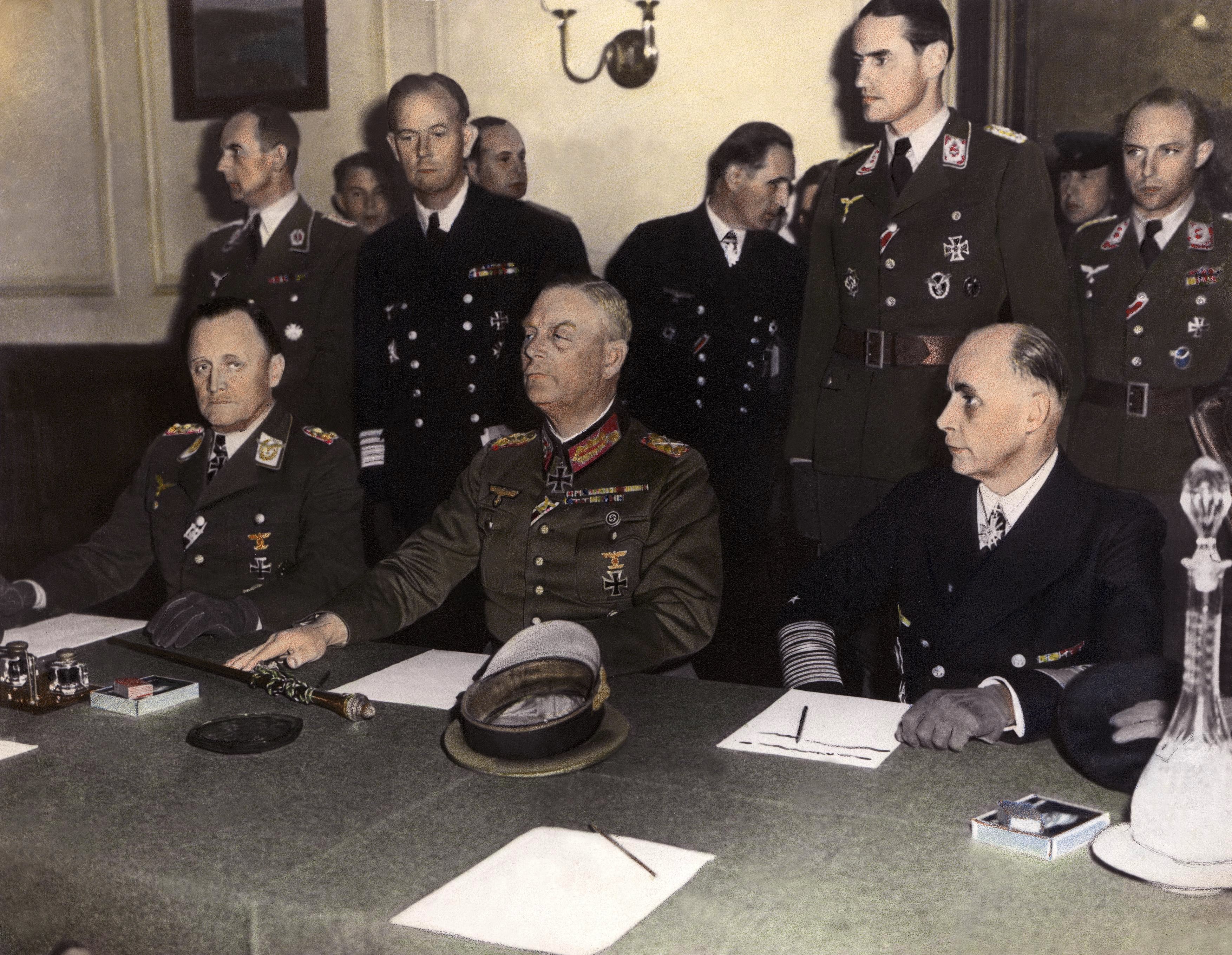 General P.H. STUMPF (left), representing the LUFTWAFFE, Marshall KEITEL (center), from the WEHRMACHT and Admiral George Hans FRIEDEBURG (right), from the German Navy signing an act of surrender of Germany at the Russian headquarters of Karlshortst, North-East of Berlin.