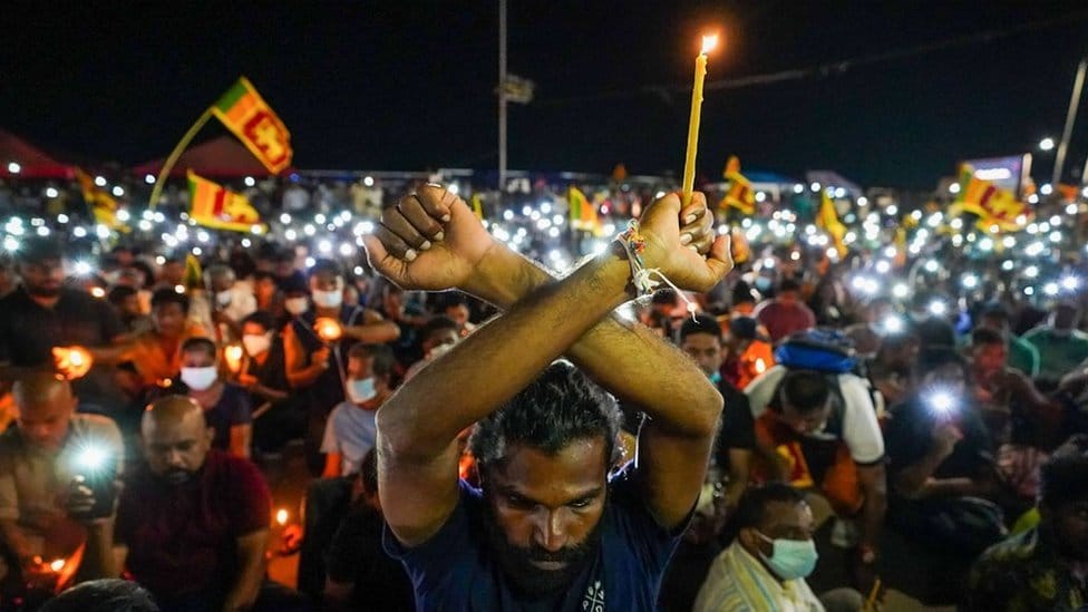 Demonstrators lights candles and flash mobile phone lights during a silent protest to pay respect to the victims of the 2019 Easter Sunday suicide bombings at three churches and three deluxe hotels that killed almost three hundred people, on the day to mark the third anniversary of the attacks near the president's office in Colombo