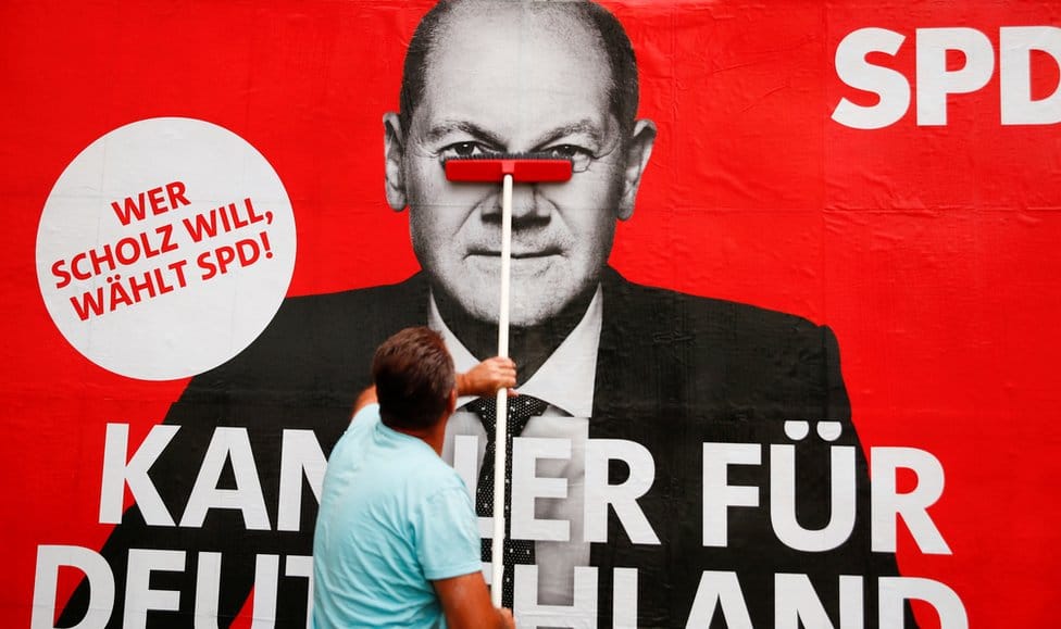 A placard of Olaf Scholz, candidate for Chancellor of Germany's Social Democratic party SPD is placed on a board for the September 26 German general elections in Bonn, Germany, September 20, 2021