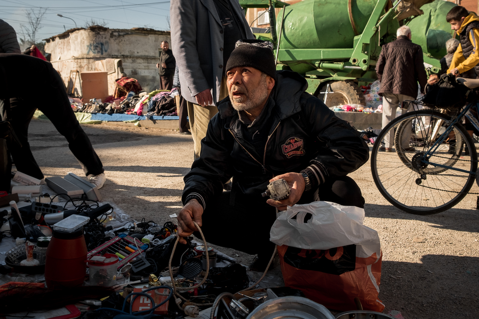 Zakir Hasam at the junk market near his home in Tirana. 'We have no ID, it interferes with every part of life," he said.