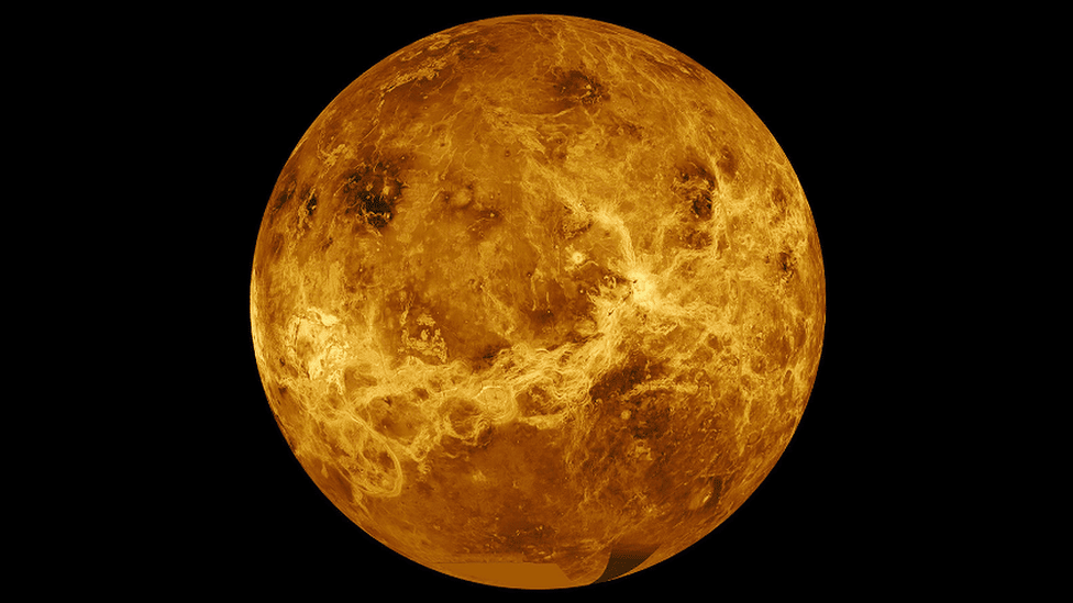 Venuus, with a number of dark ridges and brighter features