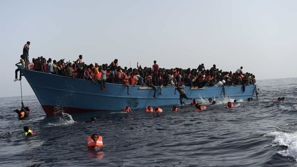 A boat full of migrants is seeing on the Mediterranean Sea