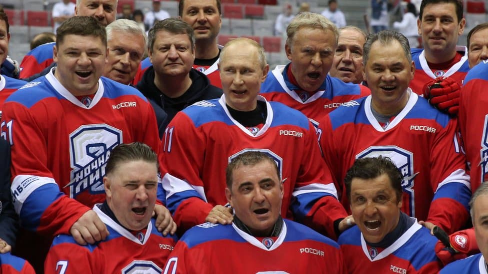 Vladimir Putin wearing ice hockey kit with teammates