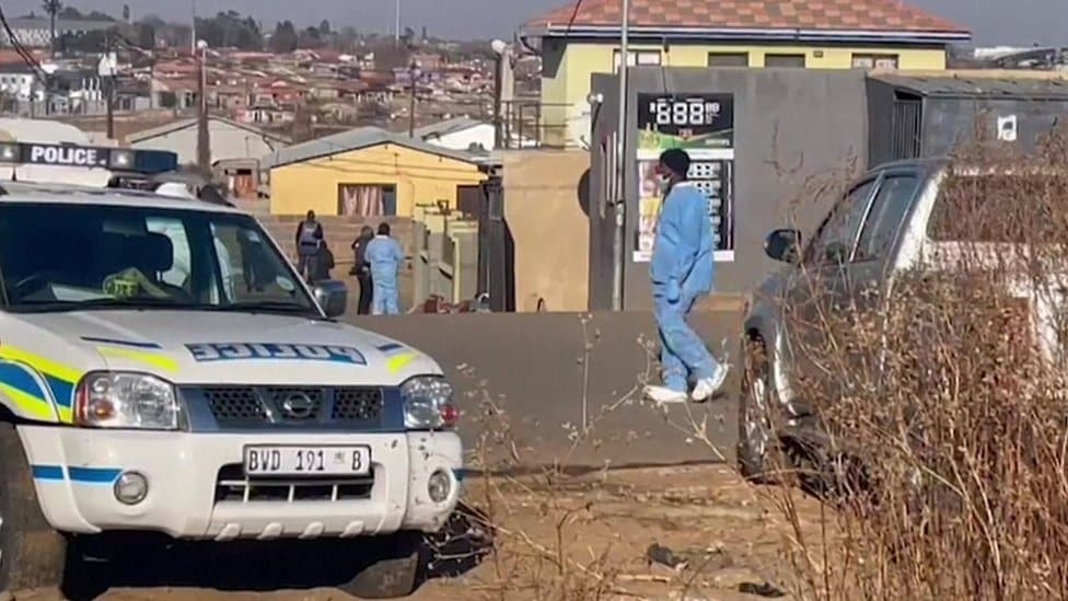 Južna Afrika: Petnaestoro ljudi ubijeno u baru 1 A police car parked in front of the bar where the shooting took place in Soweto