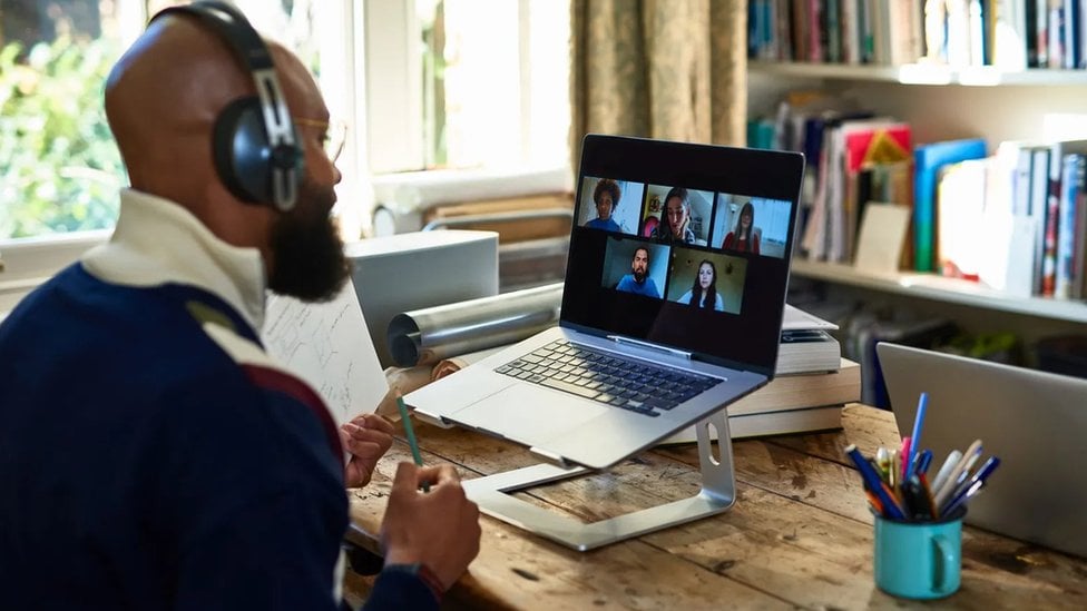 Man using laptop during video meeting