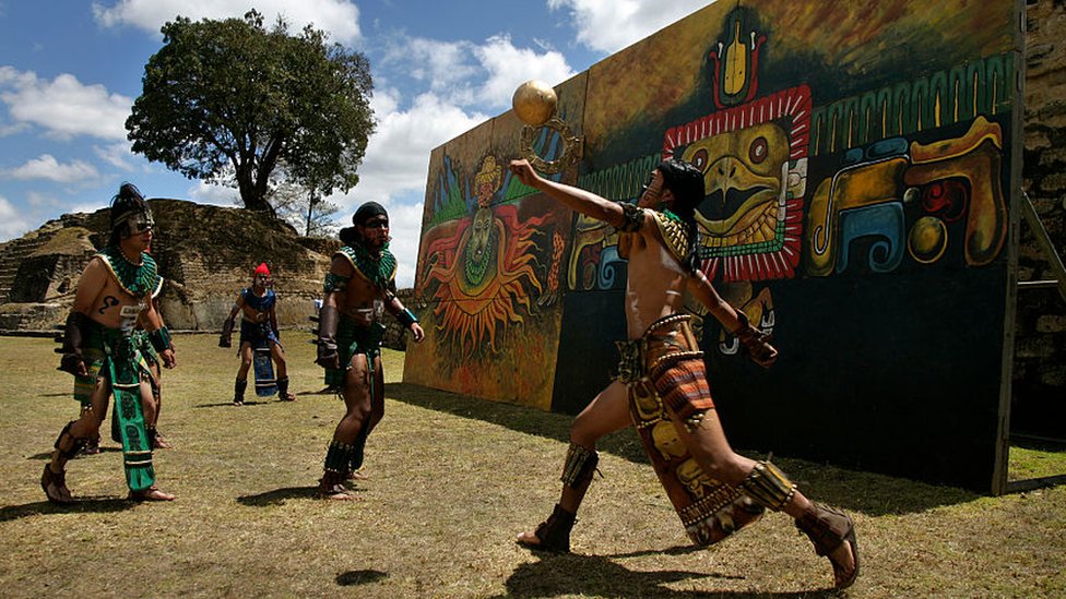 Men play an ancient Mayan ritual game called Juego de Pelota Maya, a Mayan ballgame, at the Iximche ruins.