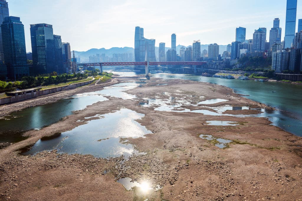 The Jialing River bed at the confluence with the Yangtze River is exposed due to drought on August 18, 2022 in Chongqing, China. The water level of the Jialing River, one of the tributaries of the Yangtze River, has dropped due to high temperature and drought
