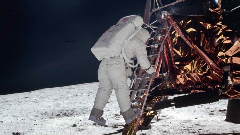 Edwin E Aldrin Jr, lunar module pilot descends the steps of the Lunar Module (LM) ladder as he prepares to walk on the moon during the Apollo 11 mission