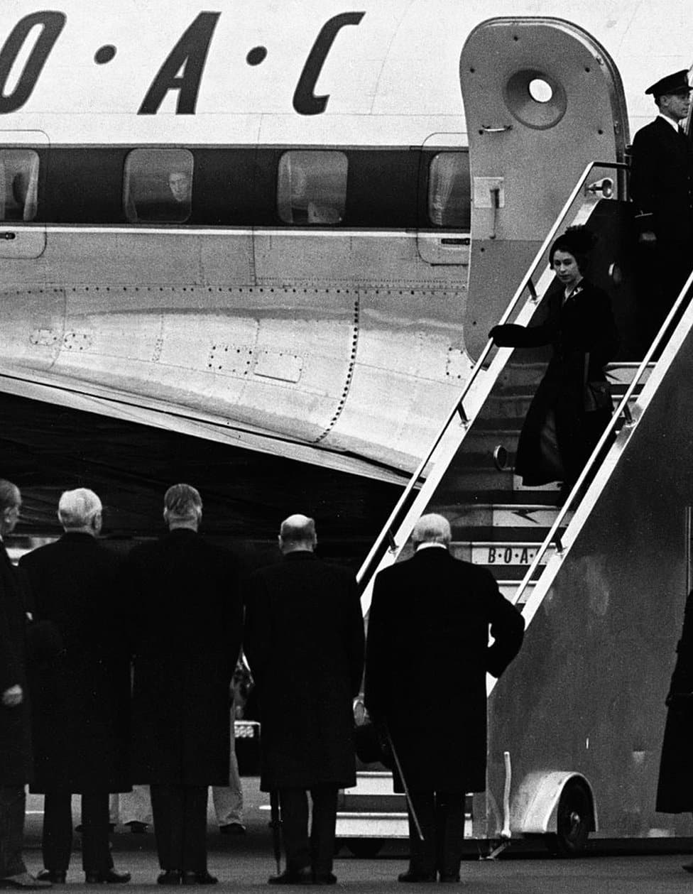 Kraljica Elizabeta Druga: Život u fotografijama 11 The Queen arrives back in Britain from Nairobi following the death of her father George VI, and is met by the politicians (second l to r) Lord Woolton, Anthony Eden, Clement Atlee and Winston Churchill.