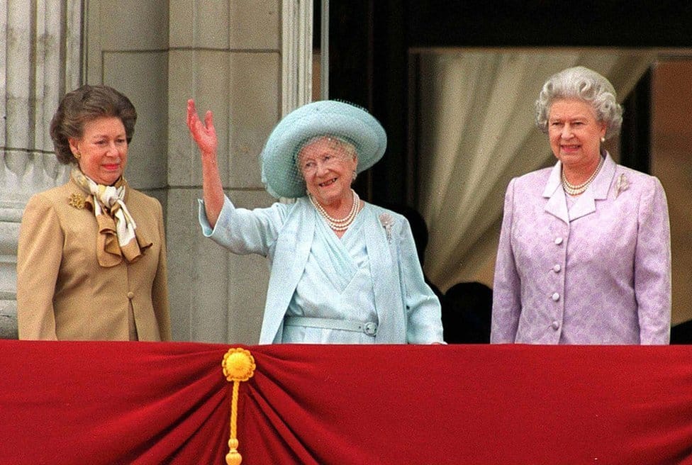 Kraljica Elizabeta Druga: Život u fotografijama 32 Princess Margaret (L) and Queen Elizabeth (R) stand next to the Queen Mother as she waves to admirers on the occasion of her 100th birthday celebration 4 August, 2000 in London.