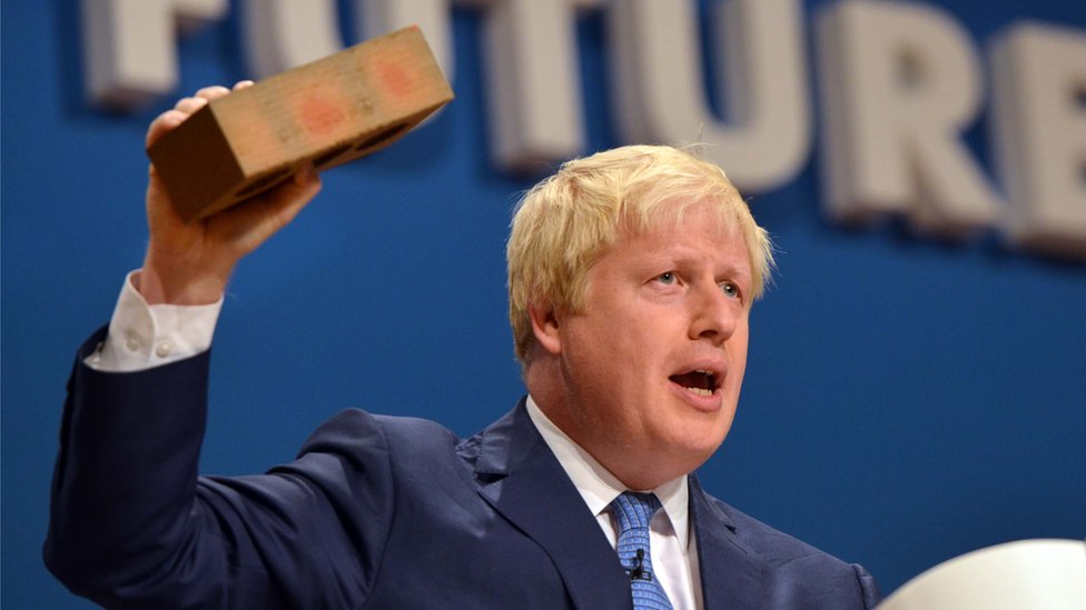 Boris Johnson holding a brick as he delivers his keynote speech to the Conservative Party Annual Conference 2014 in Birmingham,