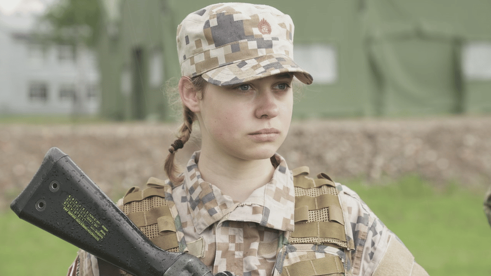 A woman holding a rifle