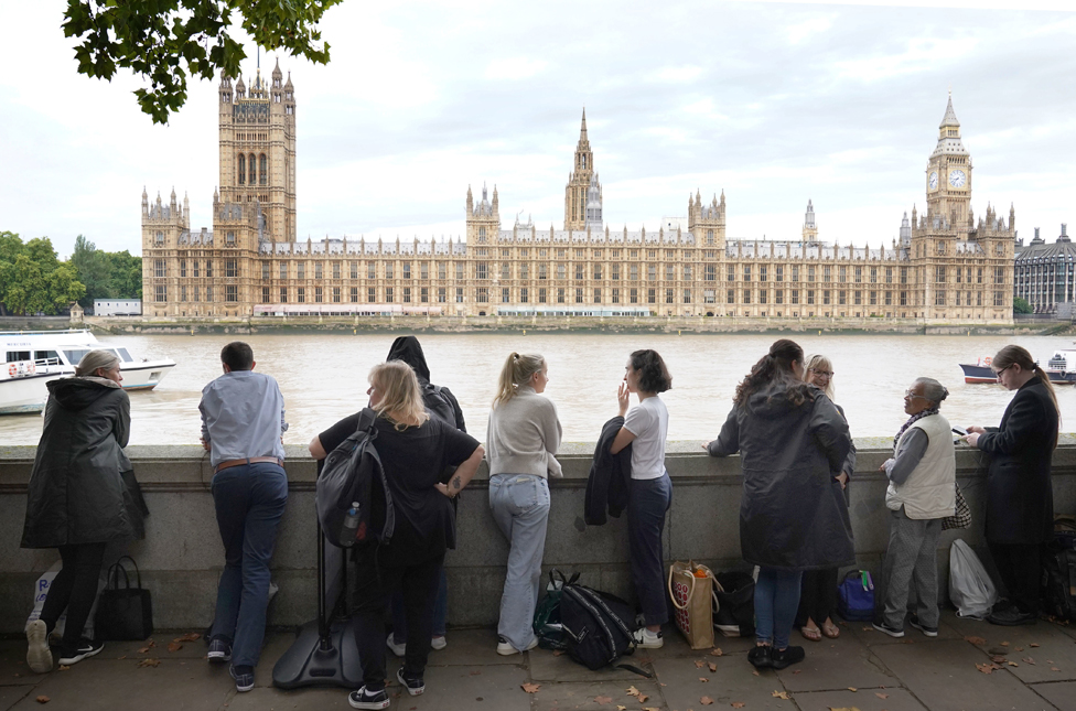 Members of the public join the queue on the South Bank, as they wait to view Queen Elizabeth II lying in state ahead of her funeral on Monday. 14 September 2022.