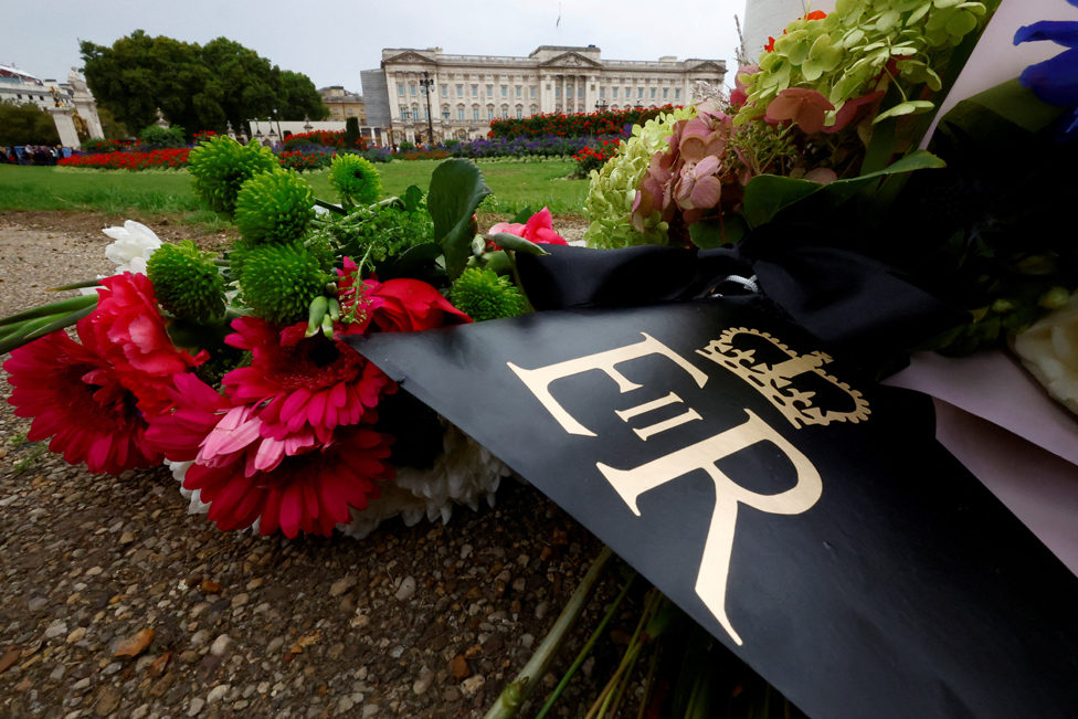 Floral tributes with the royal cypher of Britain's Queen Elizabeth are seen outside Buckingham Palace, following the queen's death, in London, Britain September 13, 2022.