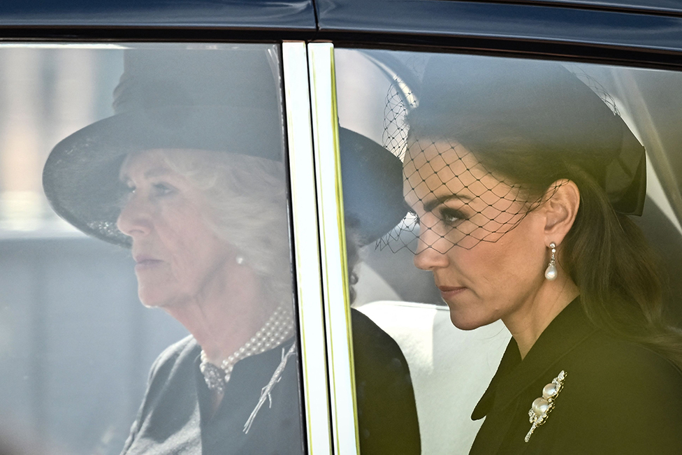 Camilla, Queen Consort and Catherine, Princess of Wales are driven behind the coffin of Queen Elizabeth II during a procession from Buckingham Palace to the Palace of Westminster, in London on 14 September 2022