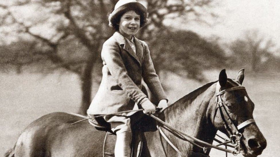 Queen Elizabeth II as a child riding a horse