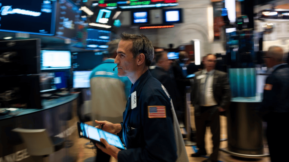 Man hurrying across trading floor of New York Stock Exchange