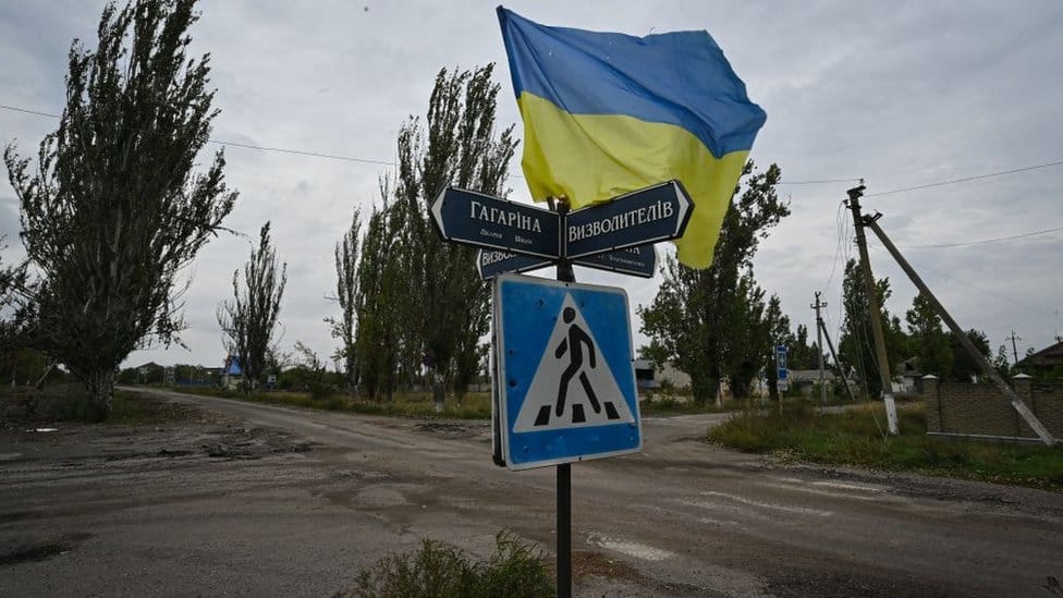 Ukrainian flag waves on a street of the recently liberated village of Vysokopillya, Kherson region