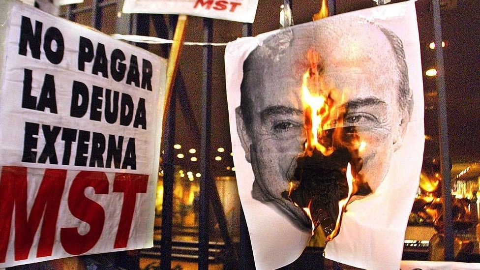 Protesters burn a picture of then Argentine President De la Rua during a protest in December 2021