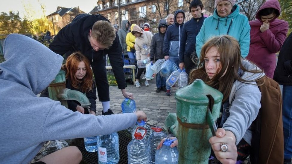 People wait in a queue to collect water from a water pump in Kyiv, Ukraine, on 31 October