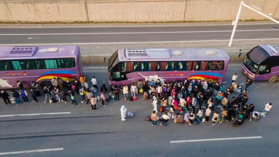Foxconn employees take shuttle buses to head home in Zhengzhou in the Henan province of China.