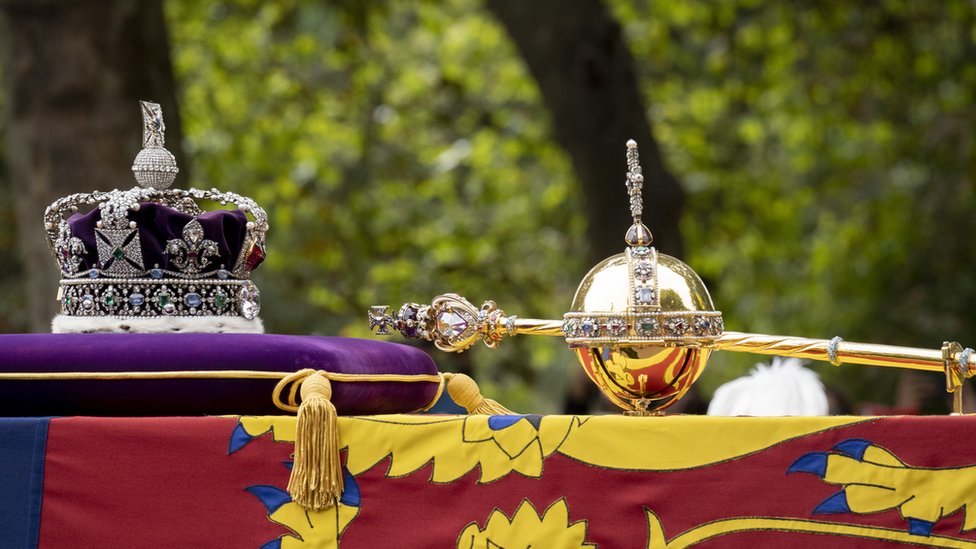 Following the death of Queen Elizabeth II, her coffin is draped with the Royal Standard and pulled on the gun carriage