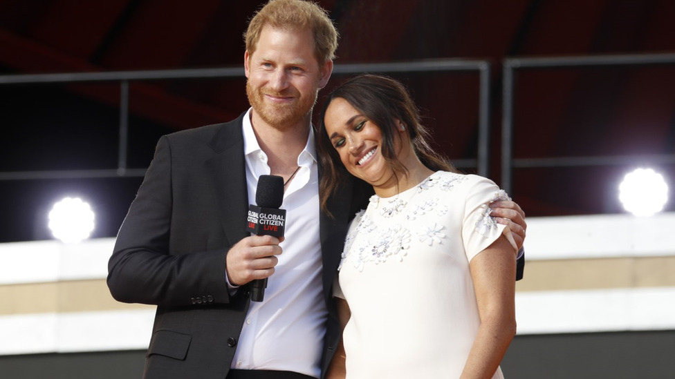 The Duke and Duchess of Sussex speaking at a public event