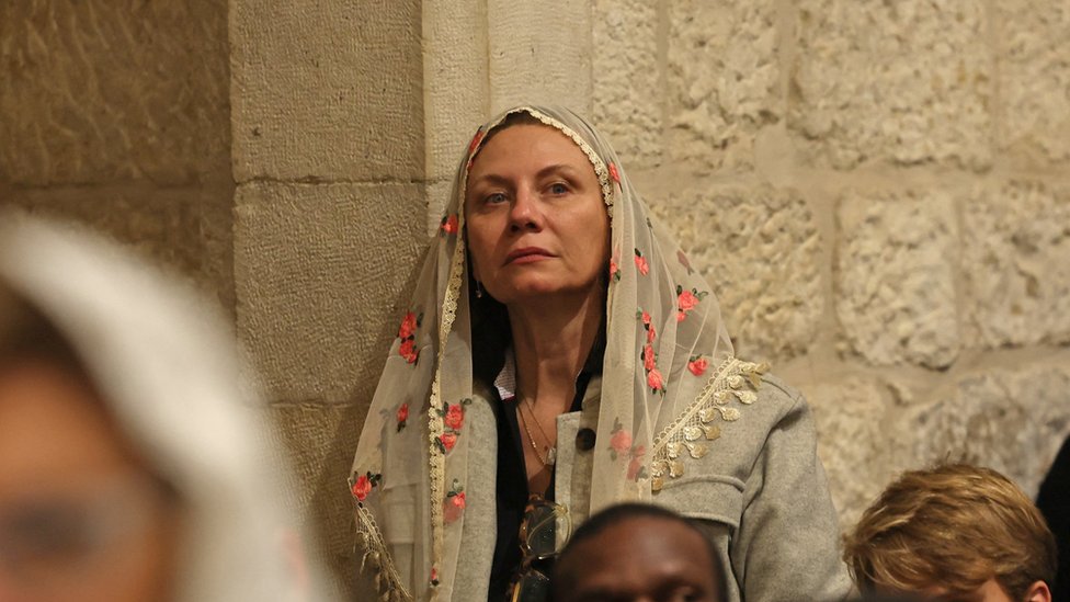 A woman wearing a veil attends Saint Catherine's Church in Bethlehem