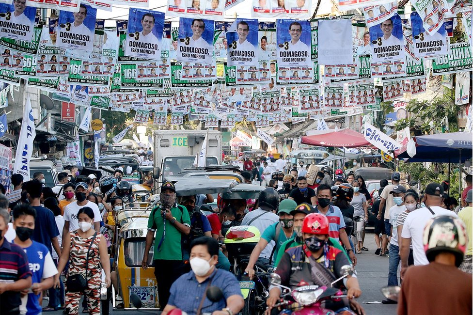 Political banners hang over a traffic-clogged street in the Port of Manila on election day, Monday, May 9, 2022.