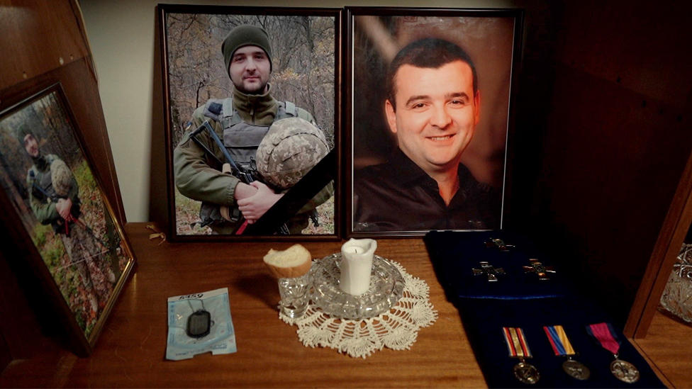 Photos of Roman in his uniform and his medals laid out at home