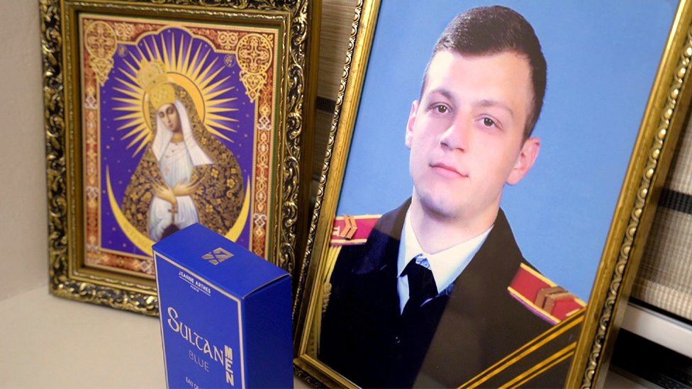 A photo of Maksym in his army uniform and the bible (CHECK)