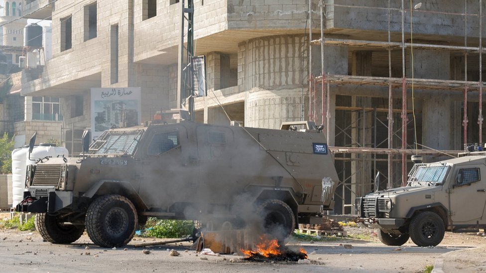 Israeli military vehicles drive through Jenin, in the occupied West Bank (26 January 2023)