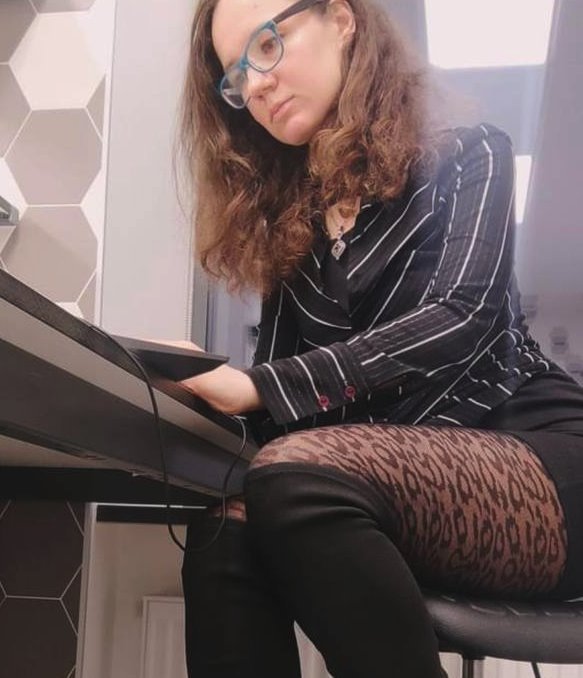Blogger Anna Arinarhkova wearing leopard skin tights sitting at a desk
