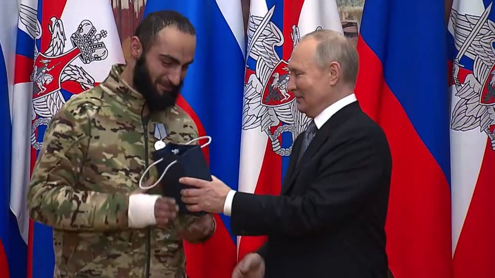 Vladimir Putin presents a state award to Wagner PMC fighter Aikom Gasparyan