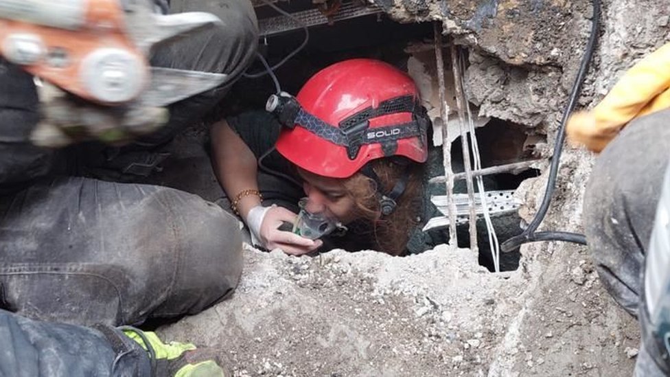 A person is rescued from the wreckage of a building